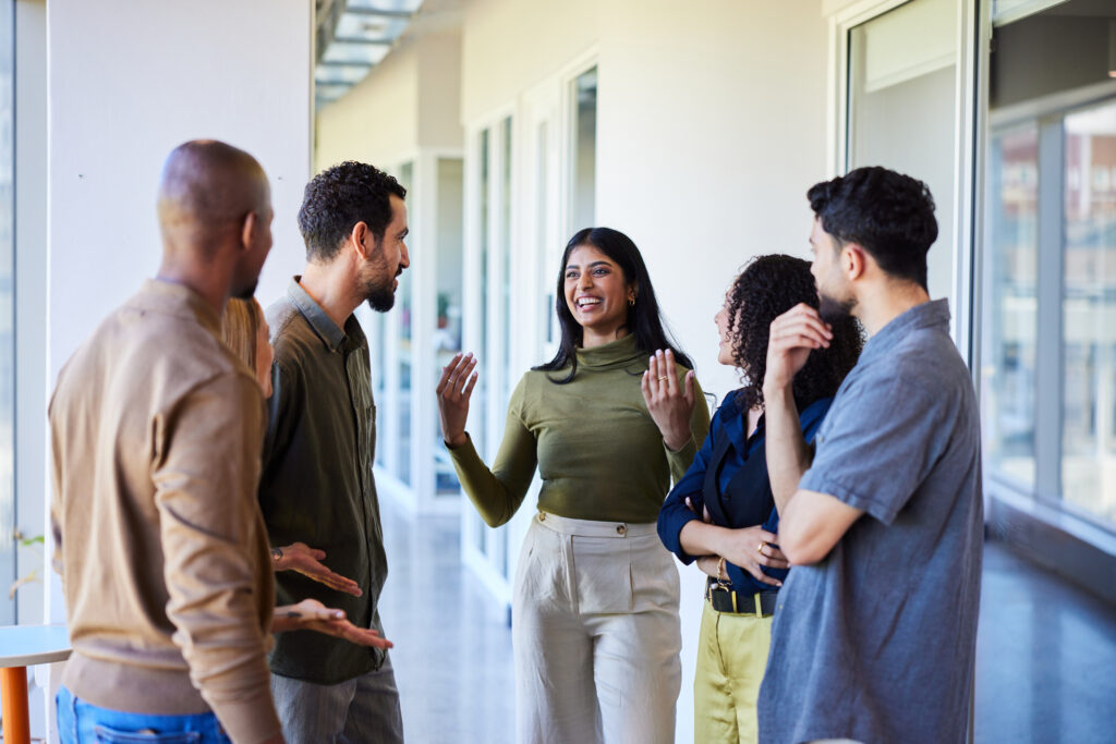 Team leader coaching colleagues in a professional setting