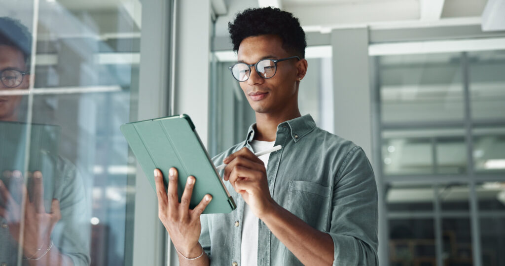 Person filling in leadership development plan on tablet